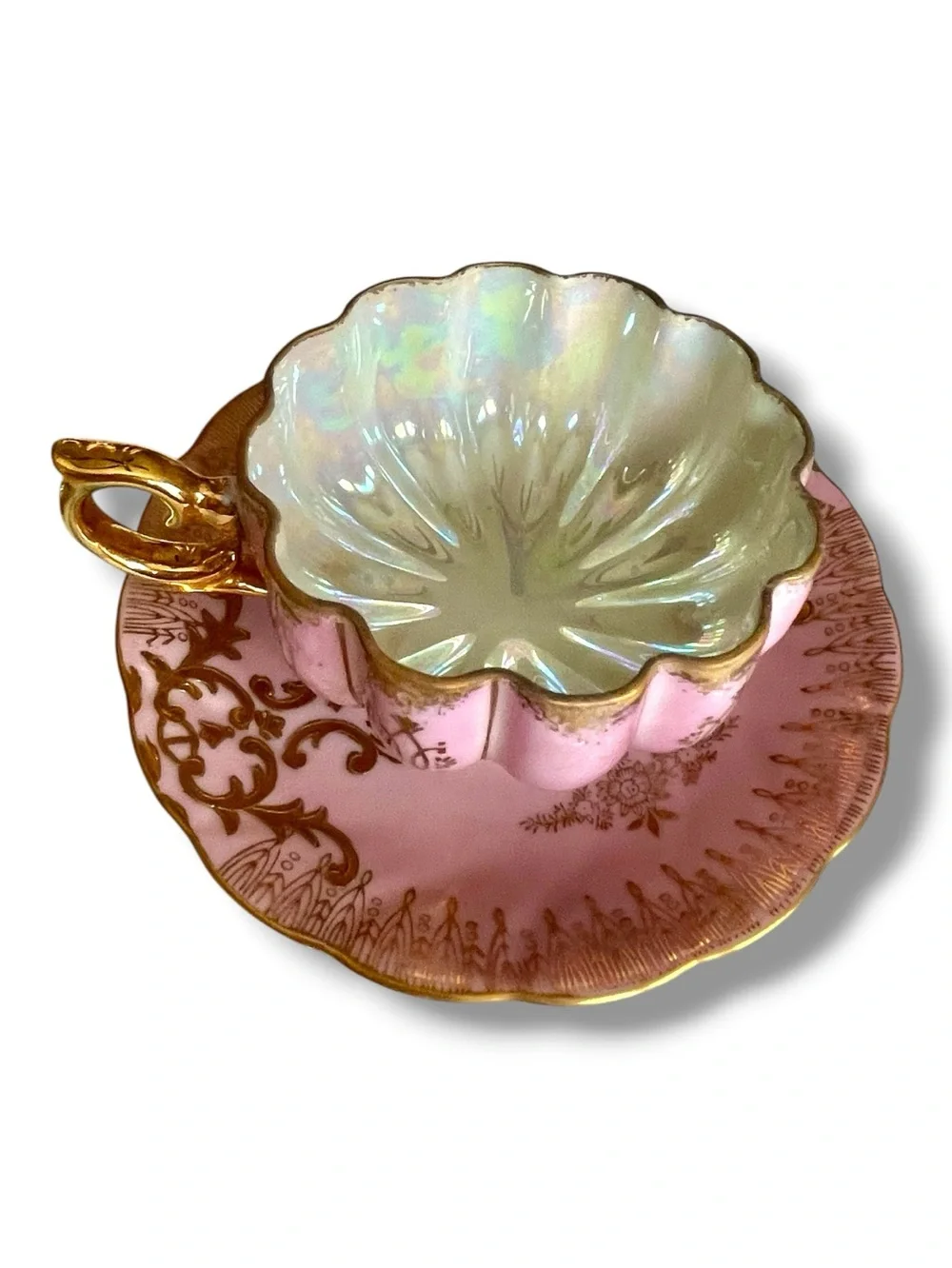 Lusterware teacup & saucer, melon shaped cup on 3 gilded feet, iridescent